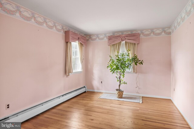 1101 Cherry Ln, Cinnaminson, NJ 08077 - spare room featuring baseboard heating, wood finished floors, and baseboards
