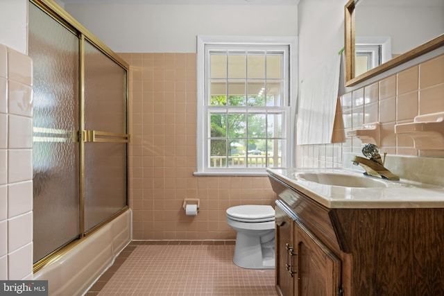 1101 Cherry Ln, Cinnaminson, NJ 08077 - bathroom with tile walls, tile patterned flooring, toilet, vanity, and bath / shower combo with glass door