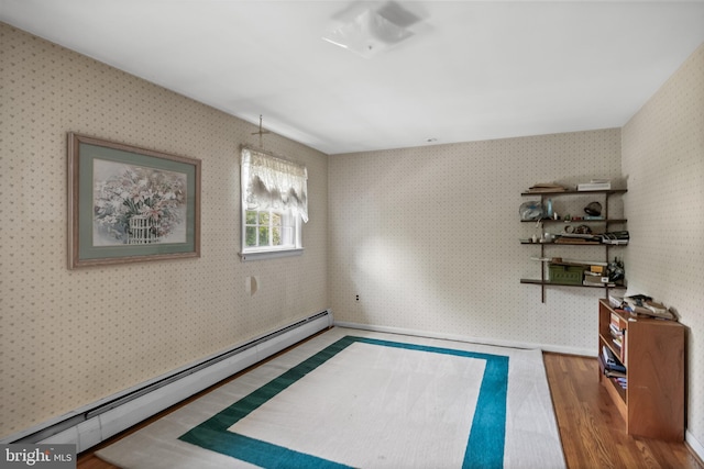 1101 Cherry Ln, Cinnaminson, NJ 08077 - empty room featuring a baseboard heating unit, wood finished floors, and wallpapered walls