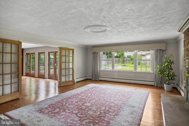 1101 Cherry Ln, Cinnaminson, NJ 08077 - living room with french doors, a textured ceiling, crown molding, a baseboard heating unit, and wood finished floors