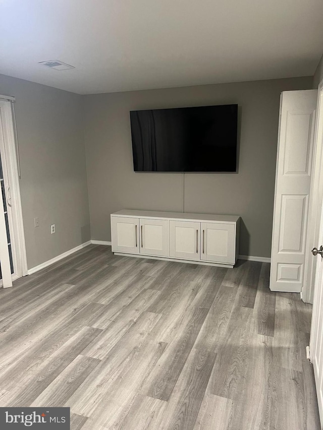 9031 Continental Pl, Landover, MD 20785 - unfurnished living room with baseboards and light wood-style floors