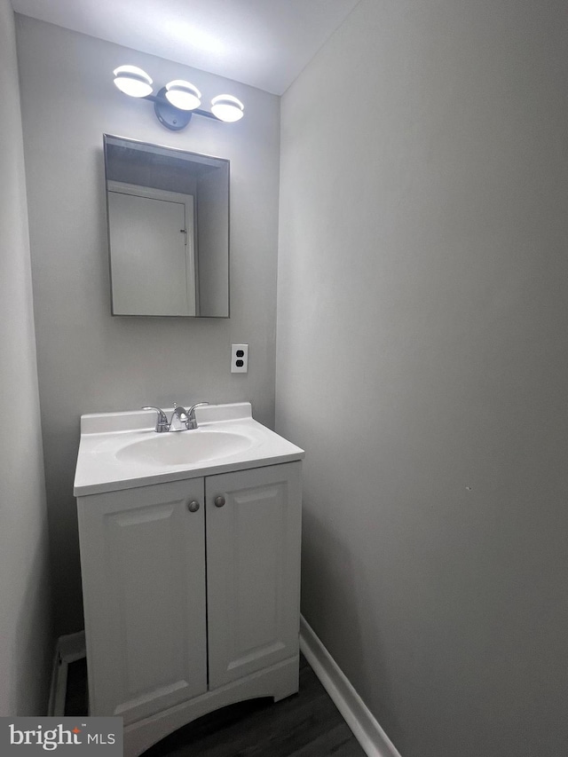 9031 Continental Pl, Landover, MD 20785 - bathroom featuring vanity, baseboards, and wood finished floors