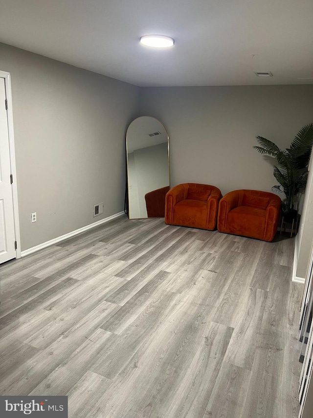 9031 Continental Pl, Landover, MD 20785 - sitting room with wood finished floors, arched walkways, and baseboards