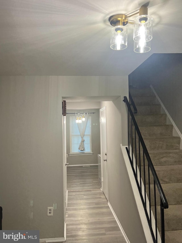 9031 Continental Pl, Landover, MD 20785 - staircase with a chandelier, wood finished floors, and baseboards