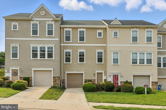 402 Woodcrest Dr SE, Washington, DC 20032 - multi unit property with stone siding, driveway, an attached garage, and a front yard