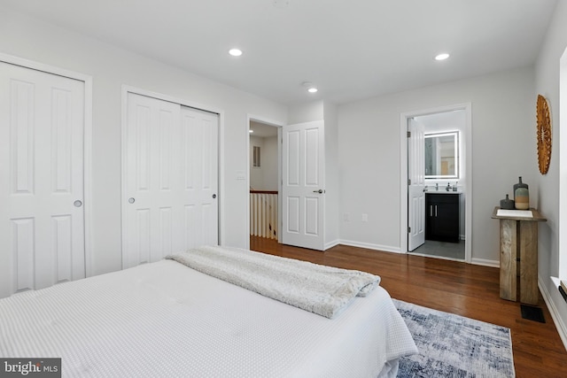 402 Woodcrest Dr SE, Washington, DC 20032 - bedroom featuring wood finished floors, multiple closets, recessed lighting, baseboards, and ensuite bath