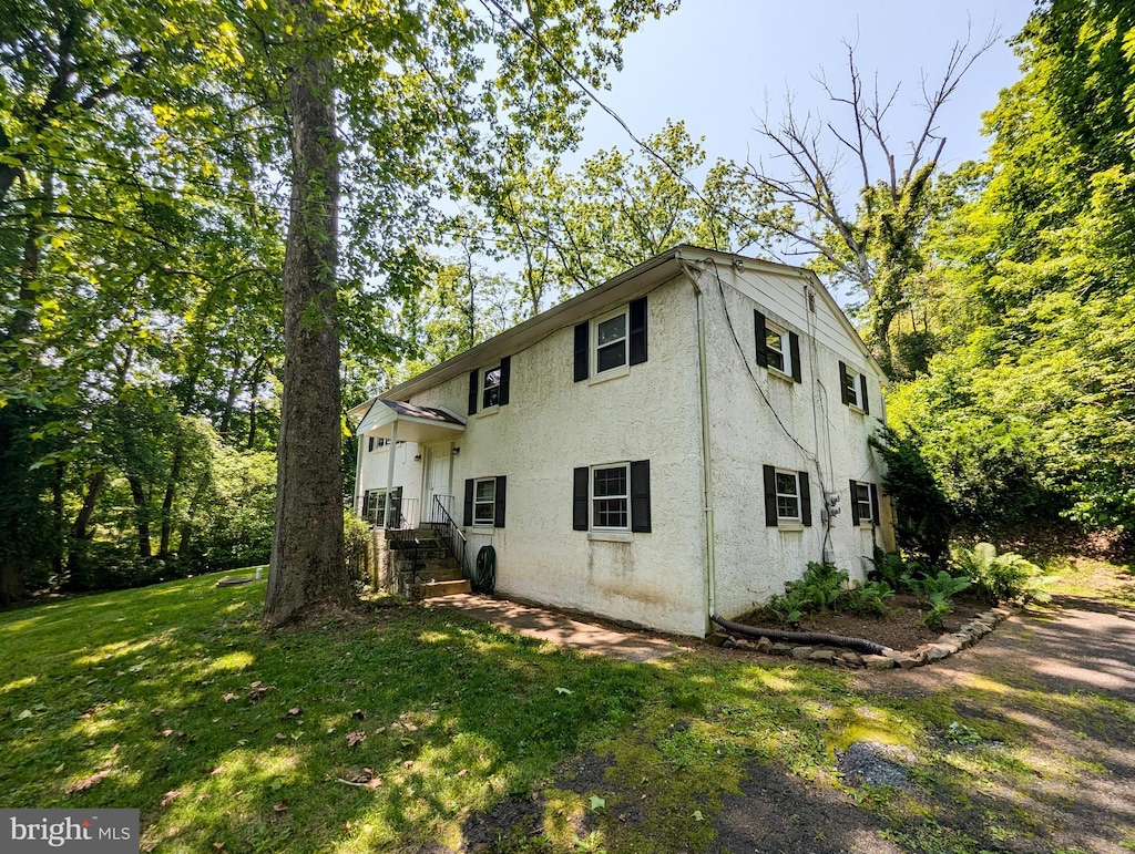 6287 Lower Mountain Rd, New Hope, PA 18938 - rear view of house with stucco siding and a yard