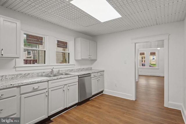 143 N 2nd St, Mount Wolf, PA 17347 - kitchen featuring dishwasher, a sink, a skylight, light wood-style flooring, and baseboards