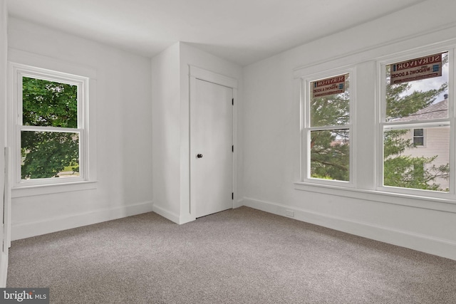 143 N 2nd St, Mount Wolf, PA 17347 - unfurnished bedroom with multiple windows, carpet floors, and baseboards