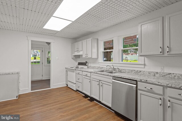 143 N 2nd St, Mount Wolf, PA 17347 - kitchen featuring dishwasher, electric stove, a sink, under cabinet range hood, and light wood-style floors
