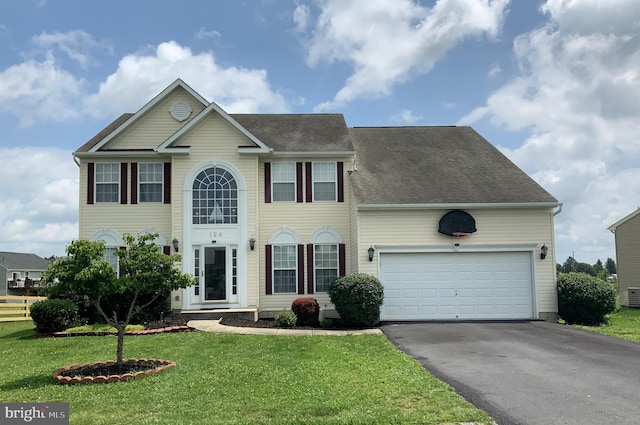 124 Chandlers Glen Dr, Bunker Hill, WV 25413 - colonial home featuring asphalt driveway, a front yard, an attached garage, a shingled roof, and cooling unit