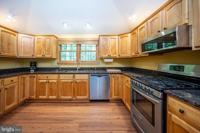 793 Mountainview Dr, Oakland, MD 21550 - kitchen with appliances with stainless steel finishes, dark stone counters, vaulted ceiling, recessed lighting, and light wood-style flooring