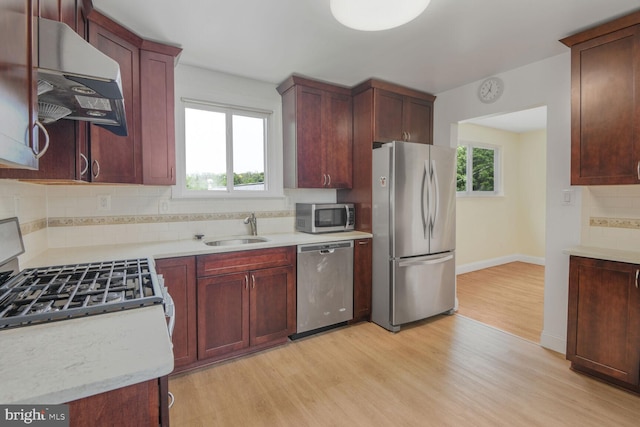 5729 Nevada St, Berwyn Heights, MD 20740 - kitchen featuring stainless steel appliances, extractor fan, light wood finished floors, decorative backsplash, and a sink