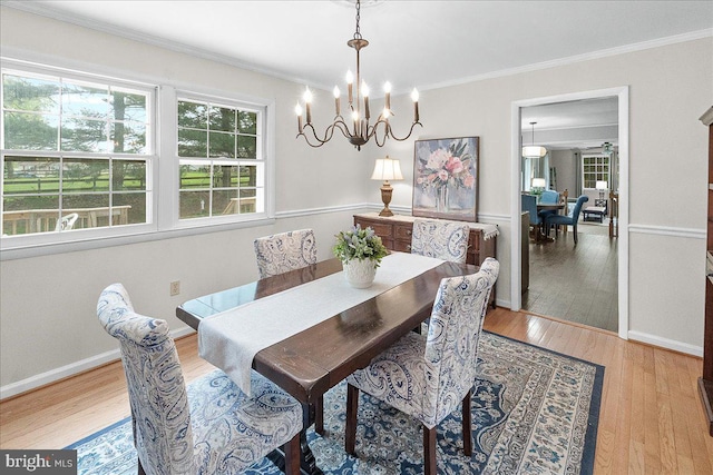 3498 Augusta Dr, Ijamsville, MD 21754 - dining room with a chandelier, light wood-style floors, and crown molding