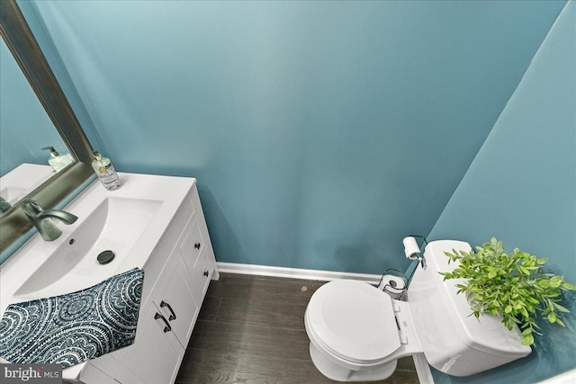 3498 Augusta Dr, Ijamsville, MD 21754 - half bathroom featuring toilet, vanity, baseboards, and wood finished floors