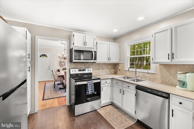 3498 Augusta Dr, Ijamsville, MD 21754 - kitchen featuring appliances with stainless steel finishes, a sink, light countertops, white cabinetry, and dark wood finished floors