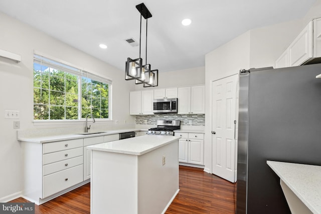 2441 Wheat Meadow Cir, Herndon, VA 20171 - kitchen featuring appliances with stainless steel finishes, decorative backsplash, dark wood-style floors, white cabinetry, and recessed lighting