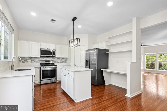 2441 Wheat Meadow Cir, Herndon, VA 20171 - kitchen featuring appliances with stainless steel finishes, open shelves, dark wood-style floors, backsplash, and light countertops