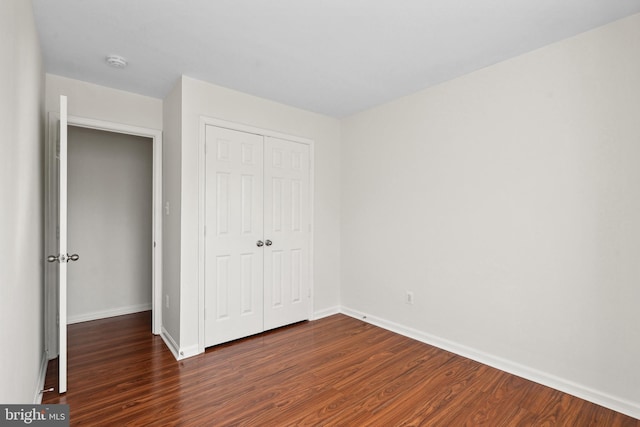 2441 Wheat Meadow Cir, Herndon, VA 20171 - unfurnished bedroom featuring dark wood finished floors and a closet