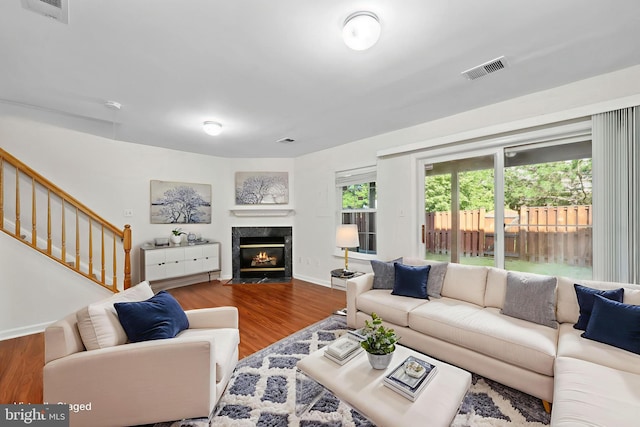 2441 Wheat Meadow Cir, Herndon, VA 20171 - living area featuring wood finished floors, a premium fireplace, and stairway