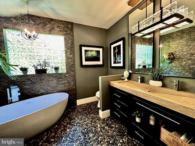 712 E Seminary Ave E, Towson, MD 21286 - full bathroom featuring a freestanding bath, baseboards, vanity, a chandelier, and toilet
