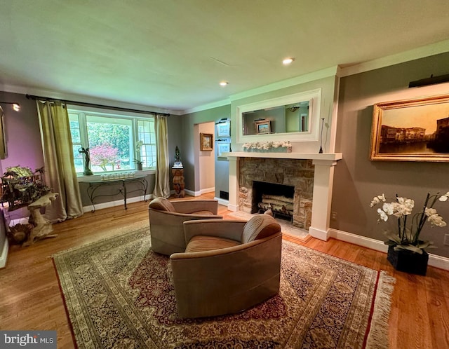 712 E Seminary Ave E, Towson, MD 21286 - living area featuring a stone fireplace, baseboards, wood finished floors, ornamental molding, and recessed lighting