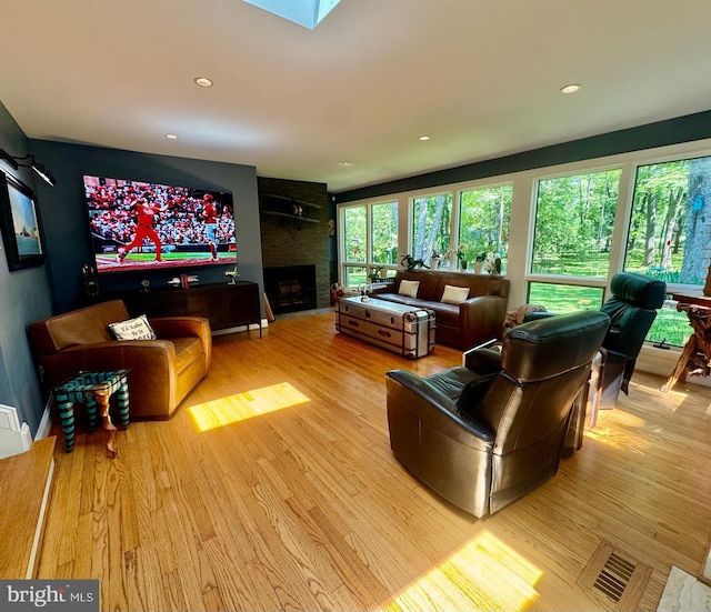 712 E Seminary Ave E, Towson, MD 21286 - living area with wood finished floors, a large fireplace, and recessed lighting