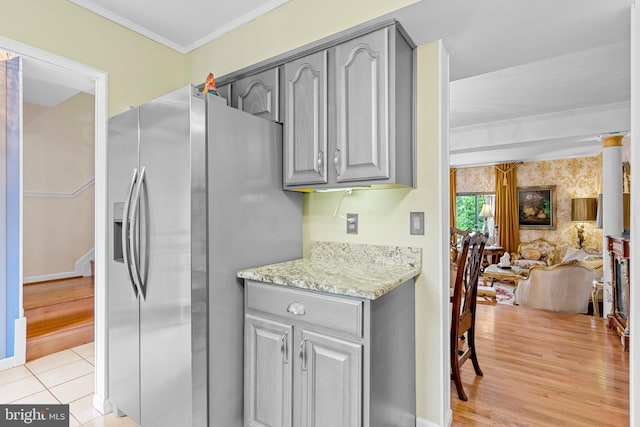 1249 Birchcrest Ct, Arnold, MD 21012 - kitchen with stainless steel refrigerator with ice dispenser, gray cabinets, open floor plan, ornamental molding, and light stone countertops