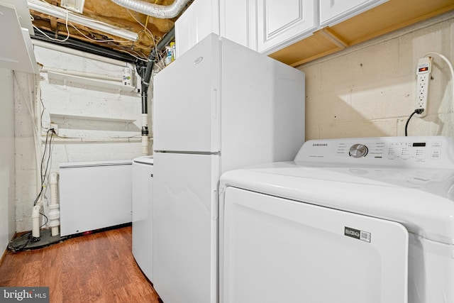1249 Birchcrest Ct, Arnold, MD 21012 - laundry room with cabinet space, light wood-style flooring, concrete block wall, and washer and dryer