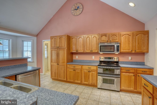 14462 Poplar St, Goldsboro, MD 21636 - kitchen featuring stainless steel appliances, high vaulted ceiling, light tile patterned flooring, a sink, and dark countertops