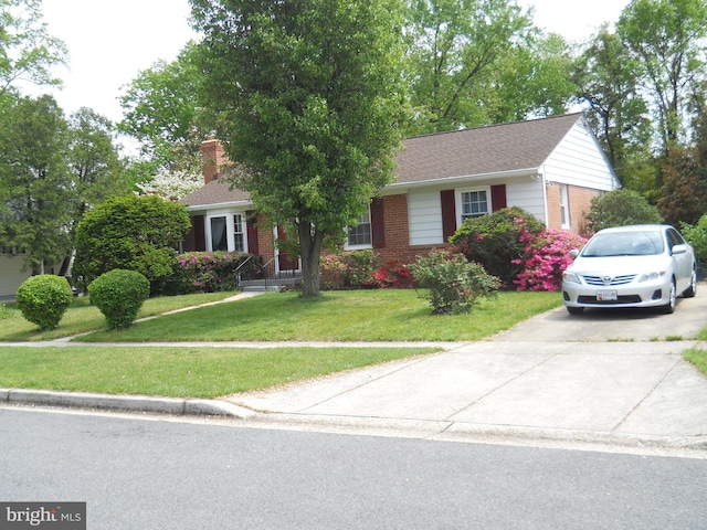 10525 Edgemont Dr, Hyattsville, MD 20783 - view of front of house featuring brick siding, a front lawn, and a chimney