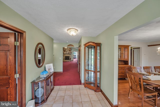 284 Little New York Rd, Rising Sun, MD 21911 - corridor featuring a chandelier, a textured ceiling, light colored carpet, and light tile patterned floors