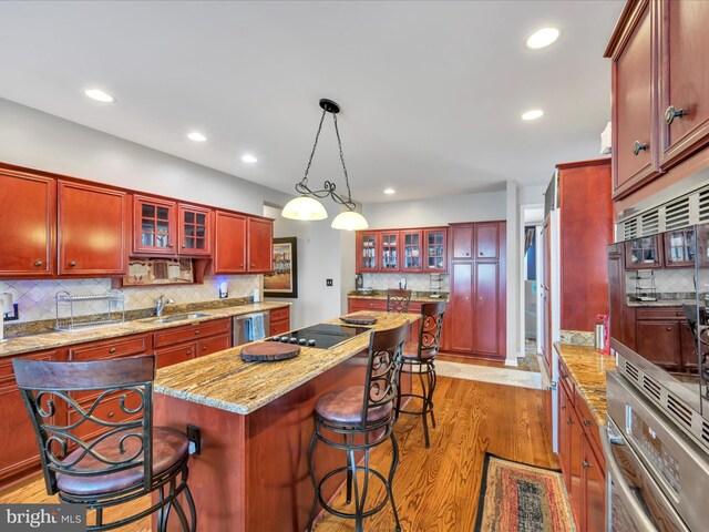 3002 Ridgeview Dr, Orwigsburg, PA 17961 - kitchen featuring stainless steel dishwasher, dark brown cabinets, backsplash, a kitchen island, and recessed lighting