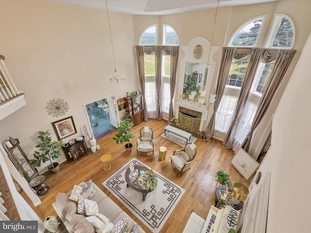 3002 Ridgeview Dr, Orwigsburg, PA 17961 - living area with a high ceiling, a chandelier, a fireplace, and wood finished floors