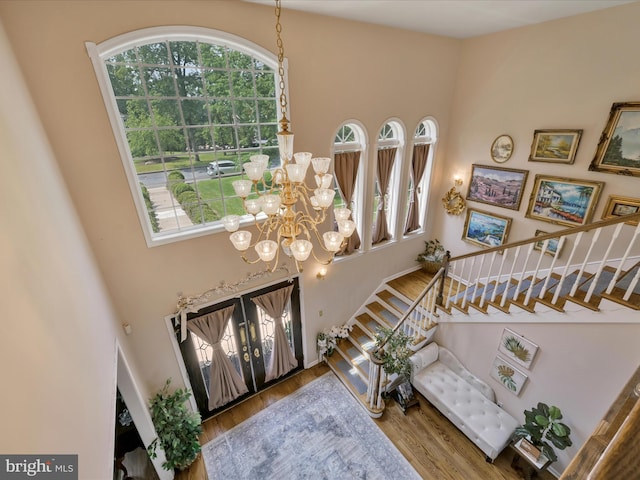 3002 Ridgeview Dr, Orwigsburg, PA 17961 - entryway featuring stairs, a high ceiling, a chandelier, and wood finished floors