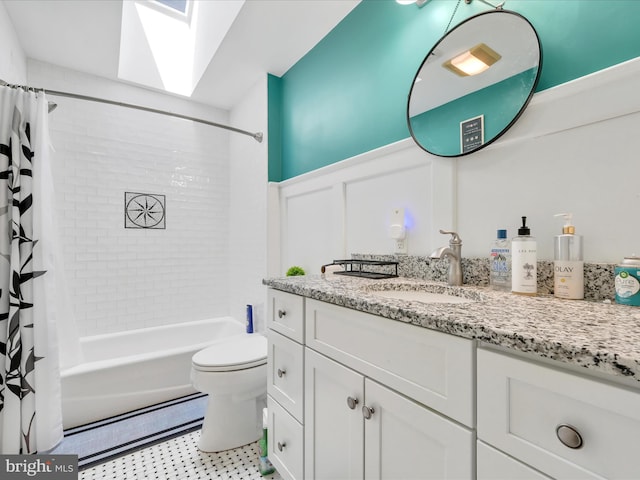 3002 Ridgeview Dr, Orwigsburg, PA 17961 - bathroom featuring vanity, shower / bath combo with shower curtain, toilet, a skylight, and a wainscoted wall