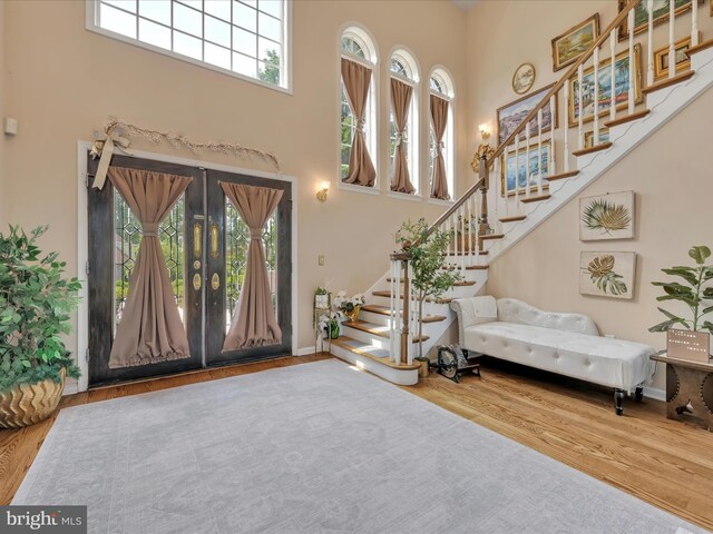3002 Ridgeview Dr, Orwigsburg, PA 17961 - foyer entrance with a towering ceiling, plenty of natural light, stairs, wood finished floors, and french doors