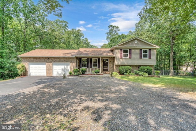 38390 Golden Beach Rd, Mechanicsville, MD 20659 - split level home with a porch, driveway, a garage, and brick siding