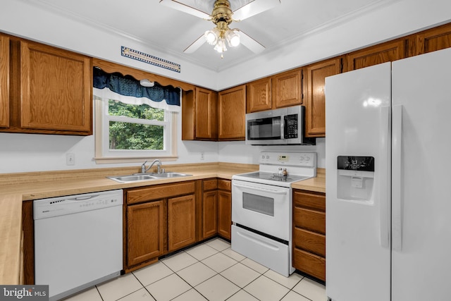 38390 Golden Beach Rd, Mechanicsville, MD 20659 - kitchen with white appliances, a sink, light countertops, brown cabinets, and ornamental molding