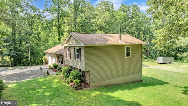 38390 Golden Beach Rd, Mechanicsville, MD 20659 - view of side of home with a lawn, a shingled roof, and a garage