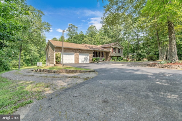 38390 Golden Beach Rd, Mechanicsville, MD 20659 - tri-level home featuring asphalt driveway and an attached garage