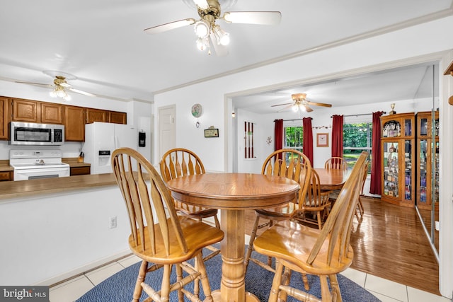 38390 Golden Beach Rd, Mechanicsville, MD 20659 - dining room featuring a ceiling fan, light tile patterned flooring, and crown molding