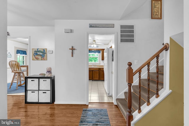 38390 Golden Beach Rd, Mechanicsville, MD 20659 - entrance foyer featuring wood finished floors, stairs, ceiling fan, and baseboards