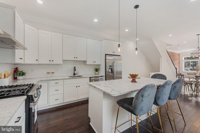 148 S E Ave, Baltimore, MD 21224 - kitchen featuring appliances with stainless steel finishes, a sink, white cabinetry, dark wood-type flooring, and recessed lighting