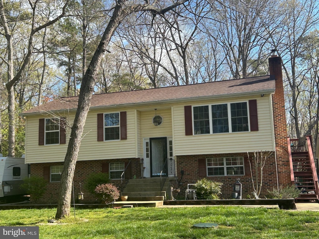 36903 Kimberly Ct, Mechanicsville, MD 20659 - raised ranch with brick siding, entry steps, a front lawn, and stairs