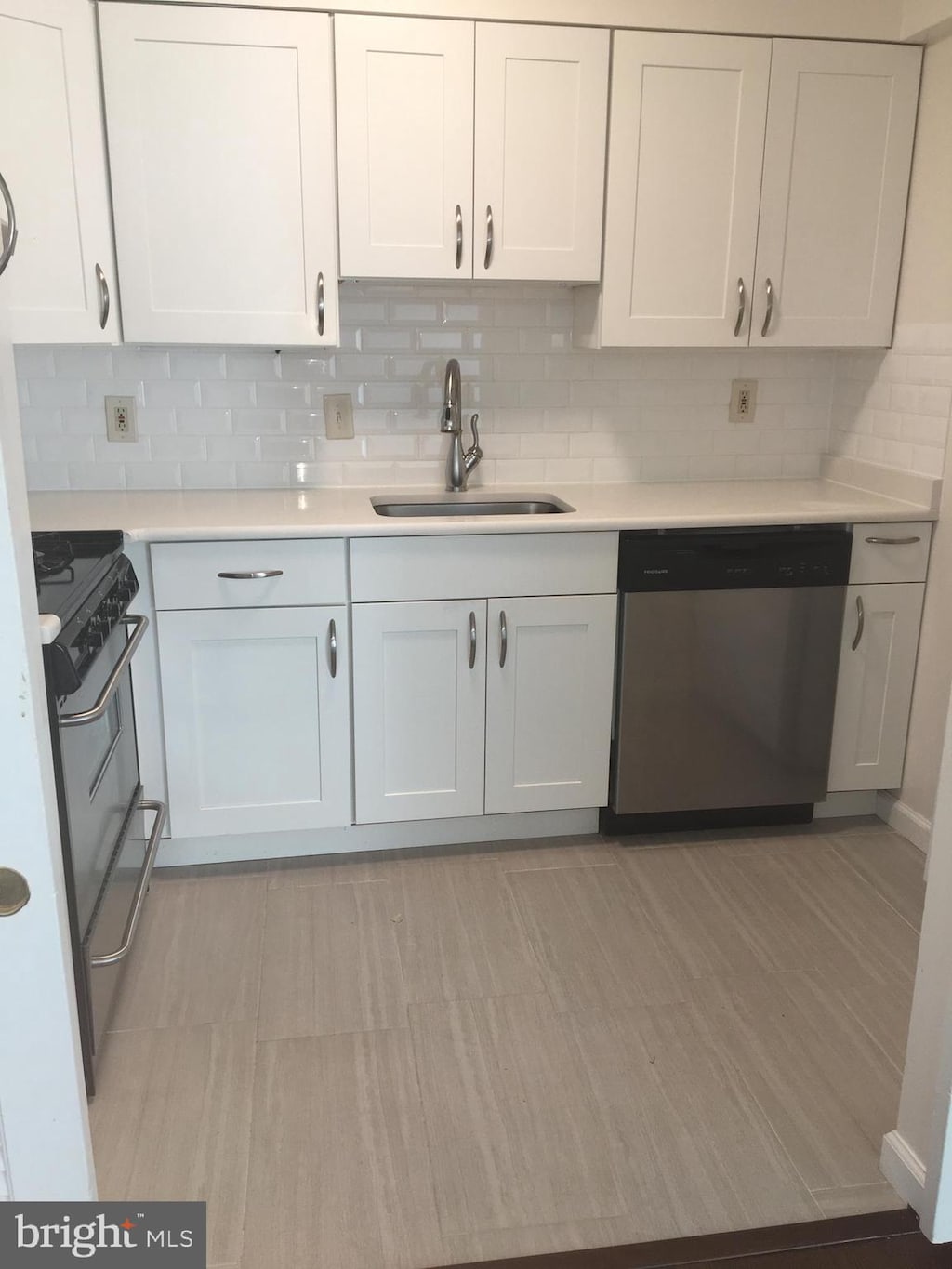 9820 Georgia Ave Unit 21-301, Silver Spring, MD 20902 - kitchen featuring dishwasher, a sink, stove, and light countertops