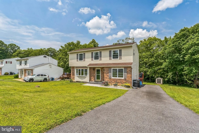 148 Belmont Dr, Upper Chichester, PA 19061 - view of front of property featuring brick siding, a front lawn, and driveway