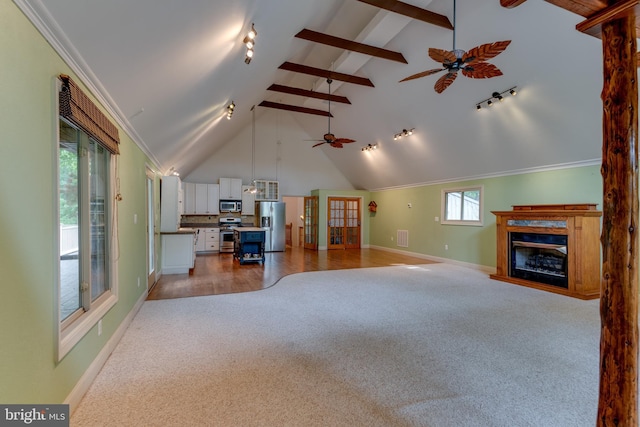26747 Cat Creek Rd, Mechanicsville, MD 20659 - living area with light carpet, a ceiling fan, a fireplace, track lighting, and beam ceiling