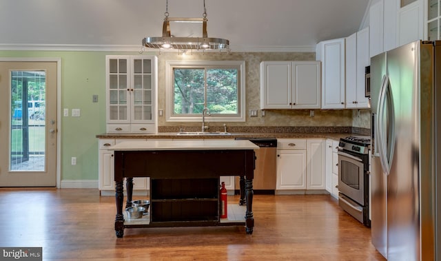26747 Cat Creek Rd, Mechanicsville, MD 20659 - kitchen featuring appliances with stainless steel finishes, a sink, wood finished floors, white cabinets, and crown molding