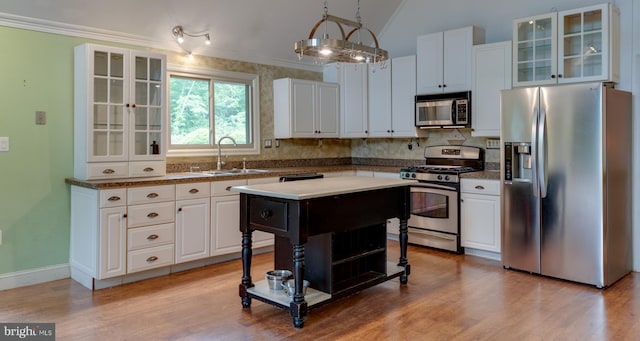 26747 Cat Creek Rd, Mechanicsville, MD 20659 - kitchen featuring appliances with stainless steel finishes, a sink, white cabinets, light wood finished floors, and lofted ceiling